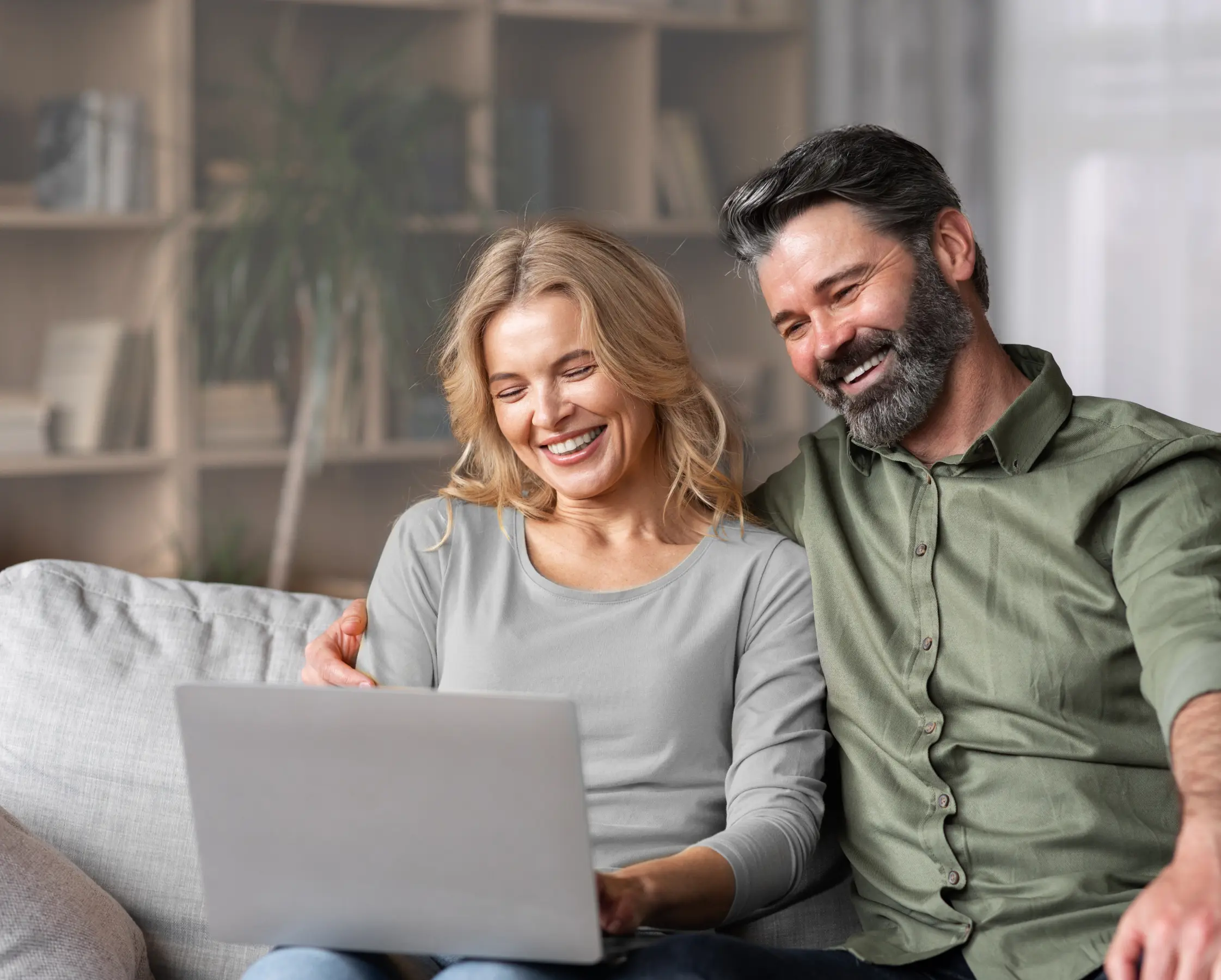 A couple watching something on their laptop